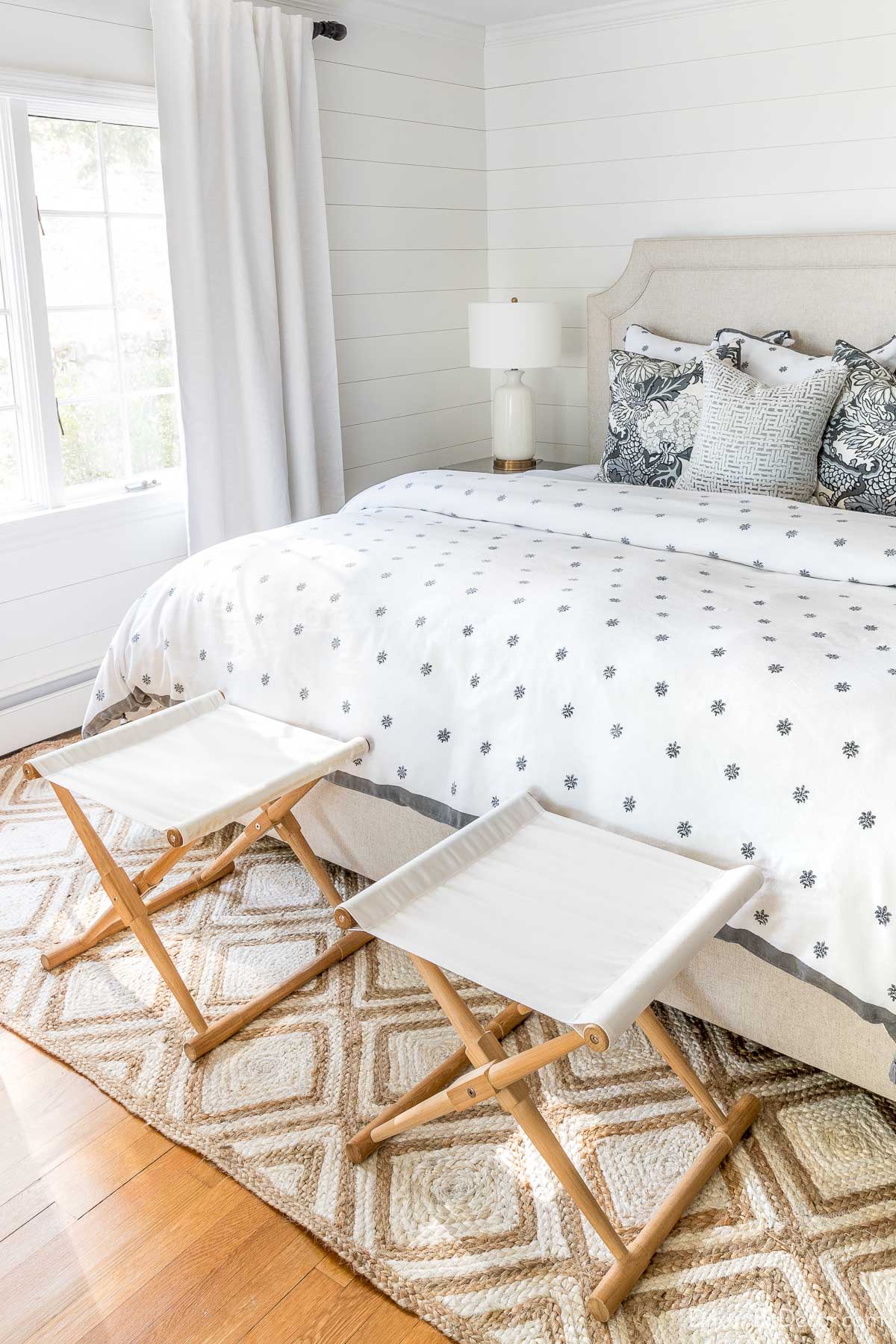 Pair of folding stools at the foot of a bed