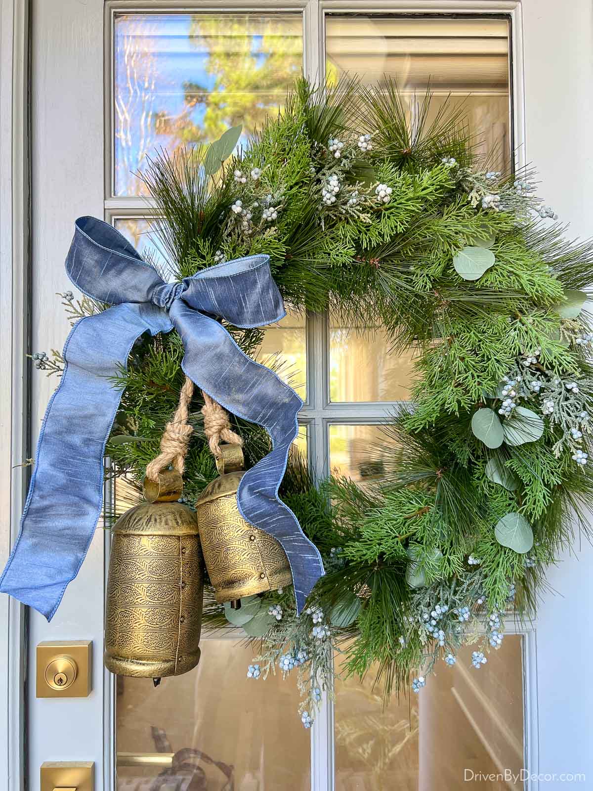 Greenery wreath with blue ribbon and two bells