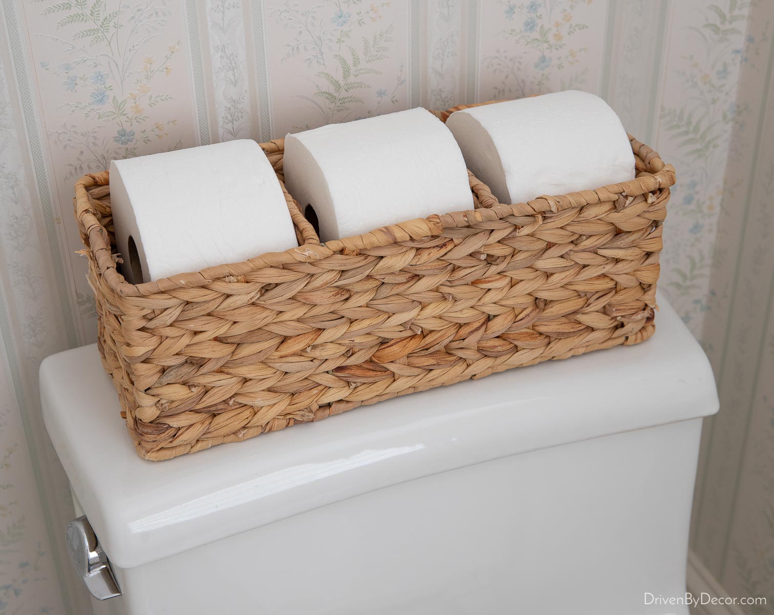 Toilet tank basket holding rolls of toilet paper