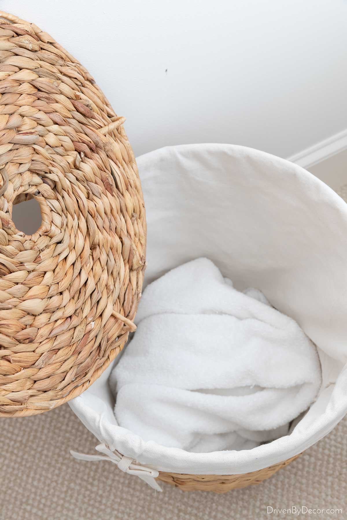 Guest Bedroom Ideas For Creating a Welcoming Retreat! Lining of woven basket used as hamper