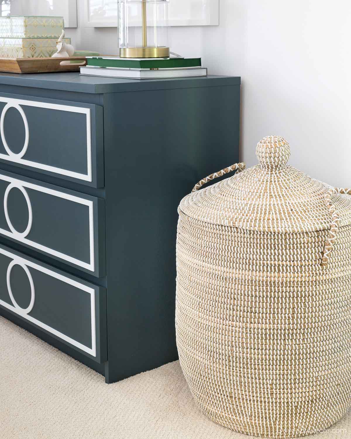 Lidded basket next to dresser in bedroom