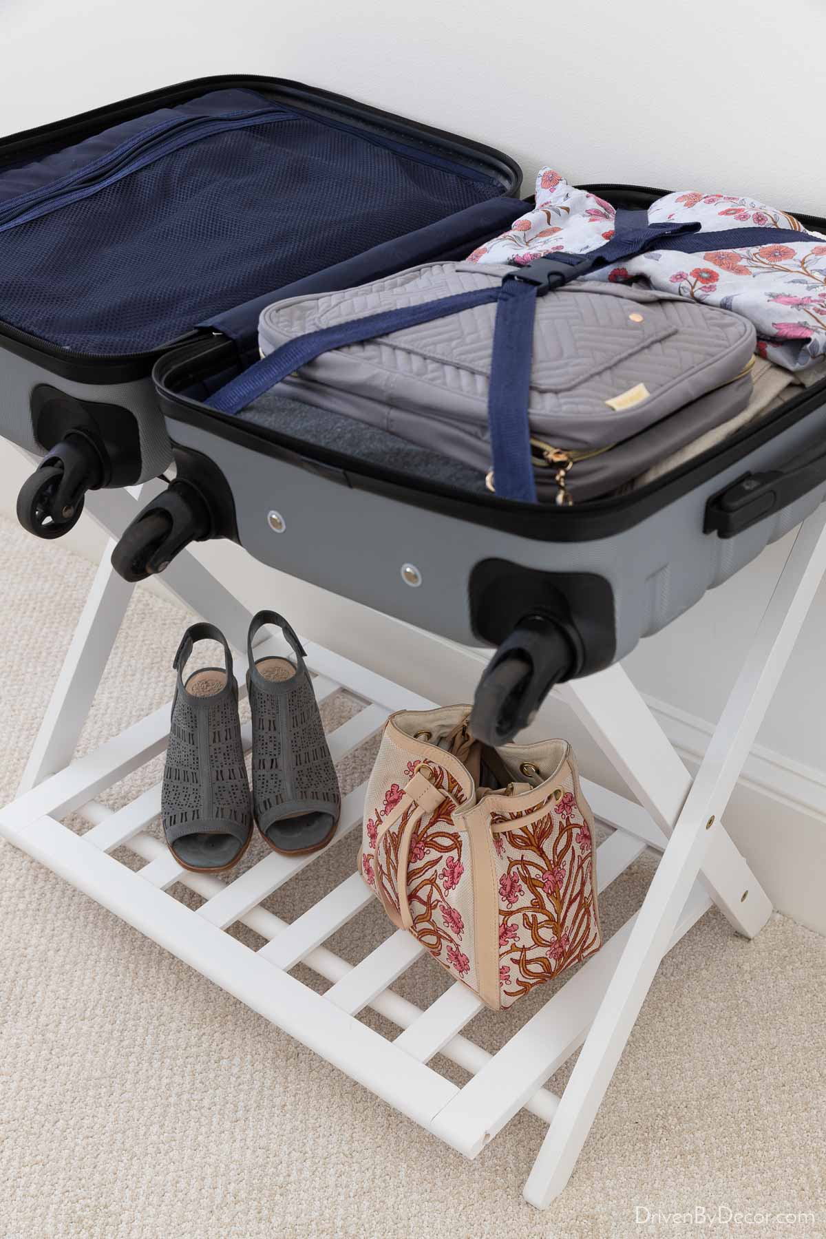 White luggage rack with suitcase on top