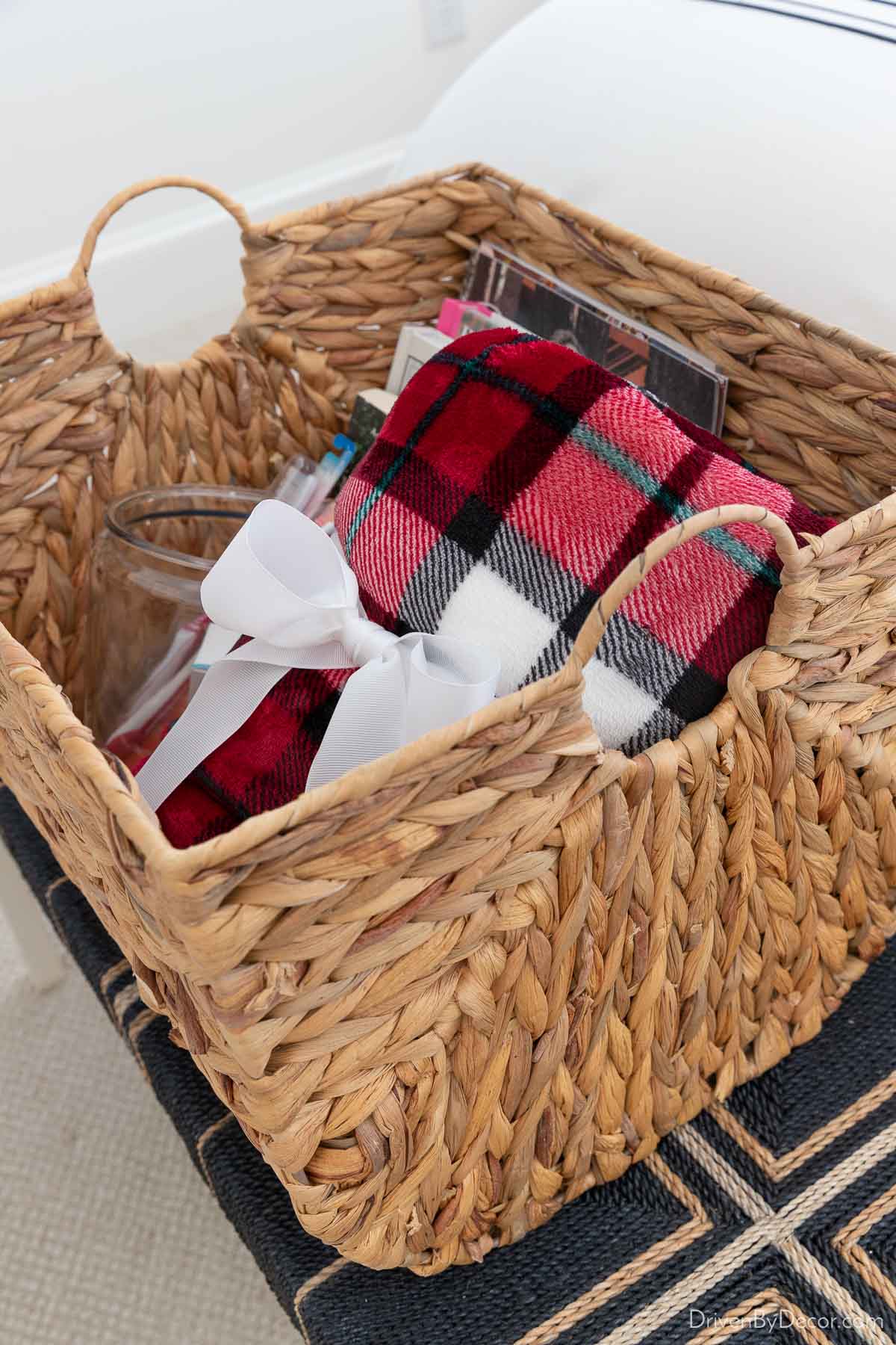 Red plaid throw blanket rolled up in basket