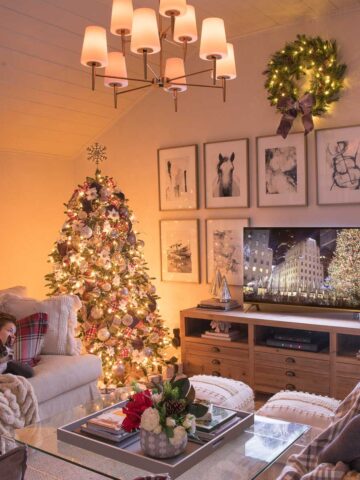 Family room decorated for Christmas with lit tree and chandelier