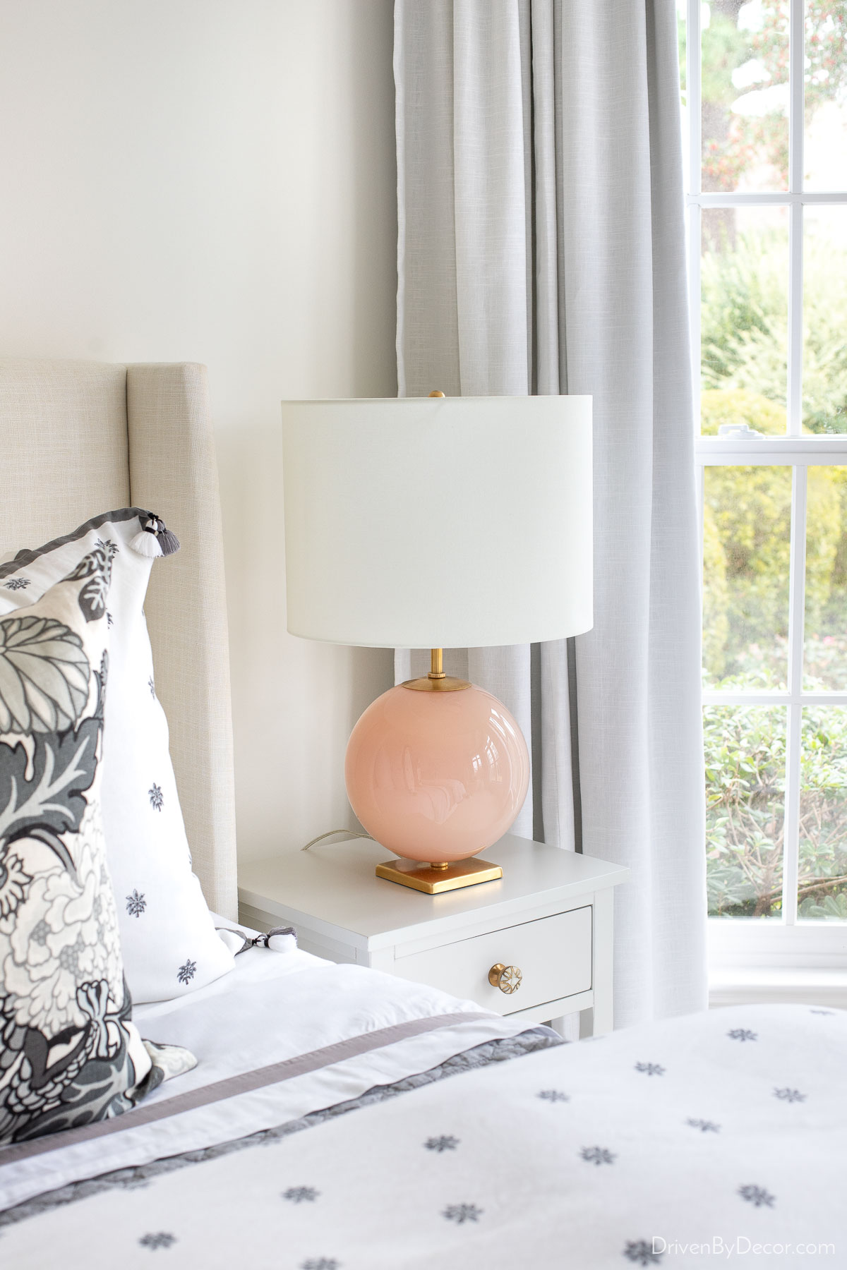 The bedroom lamps on our nightstands with a round blush base