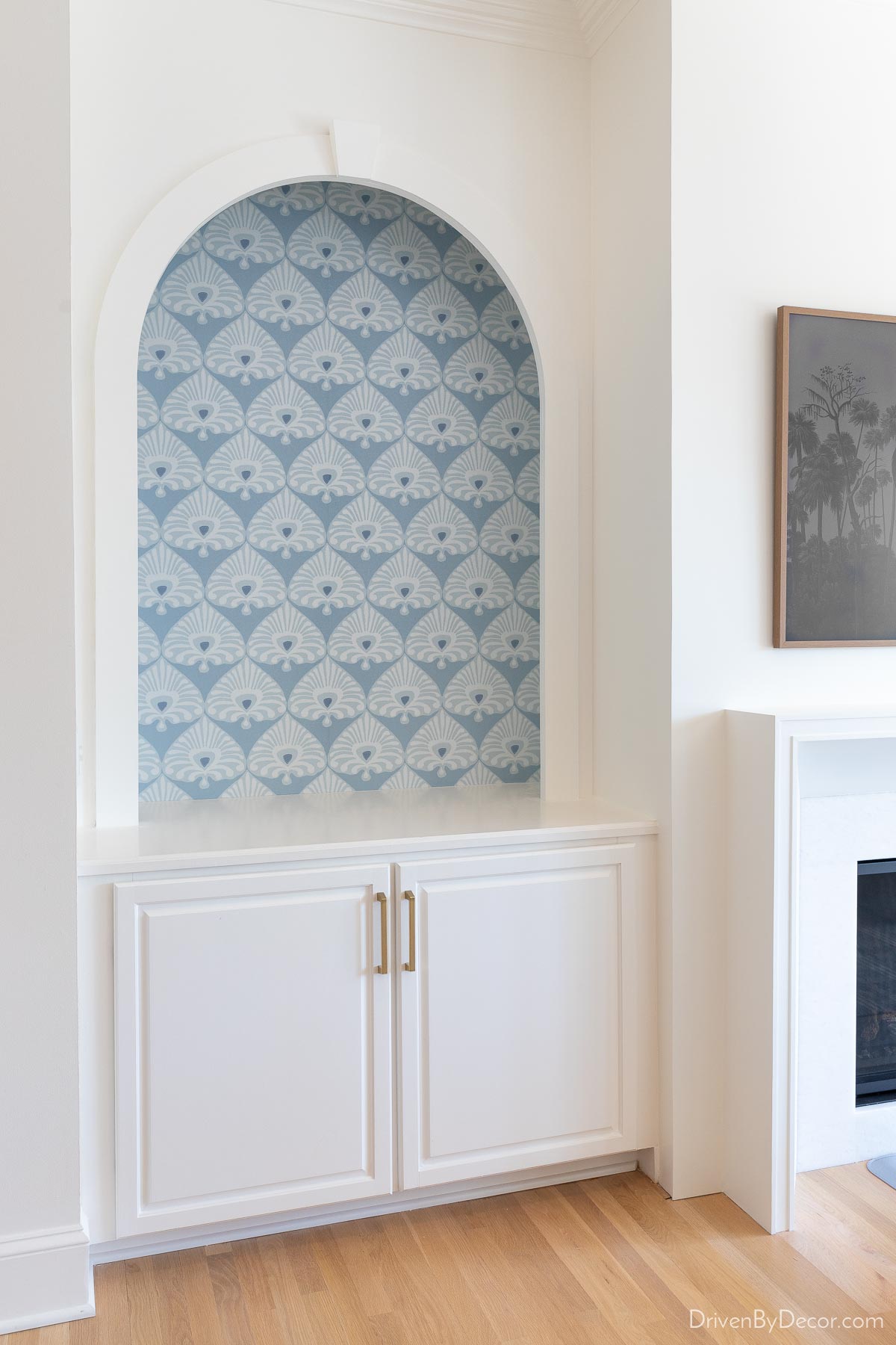 Patterned blue wallpaper on back of bookcase