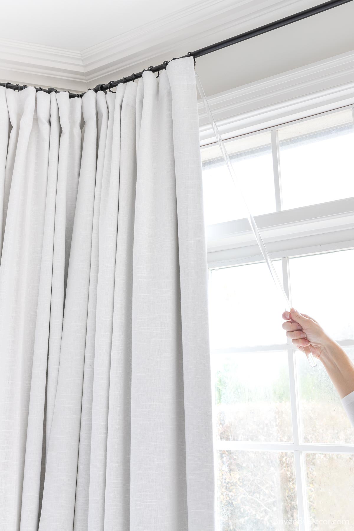Closing drapes with an acrylic curtain wand