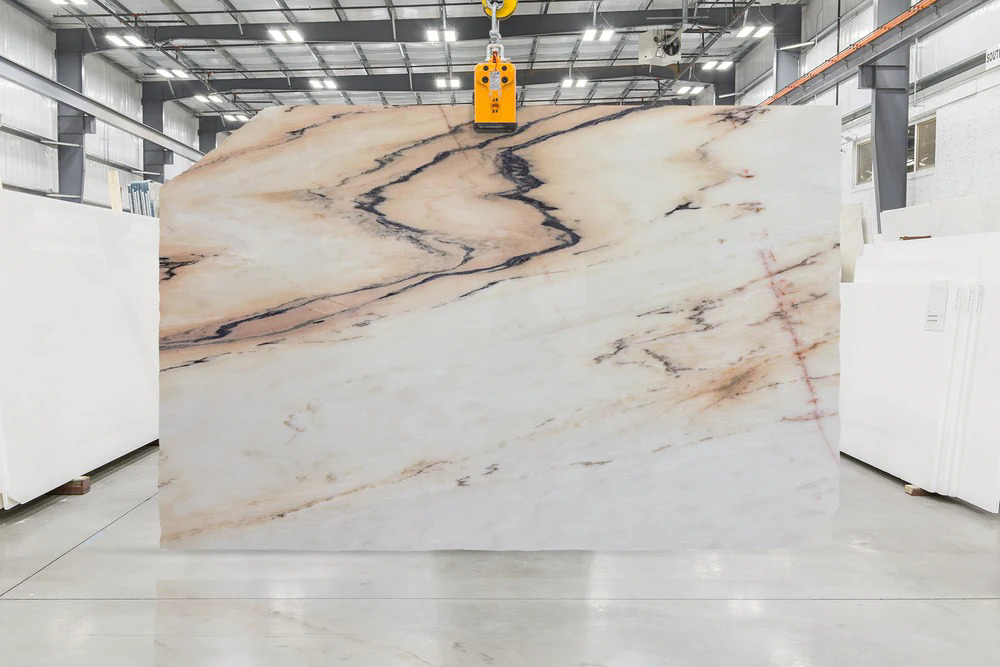 A colorful marble slab with rose pink and terracotta veining