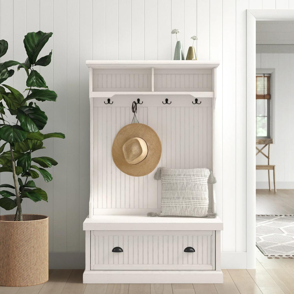 White hall tree with hooks for coats and drawers for entryway shoe storage