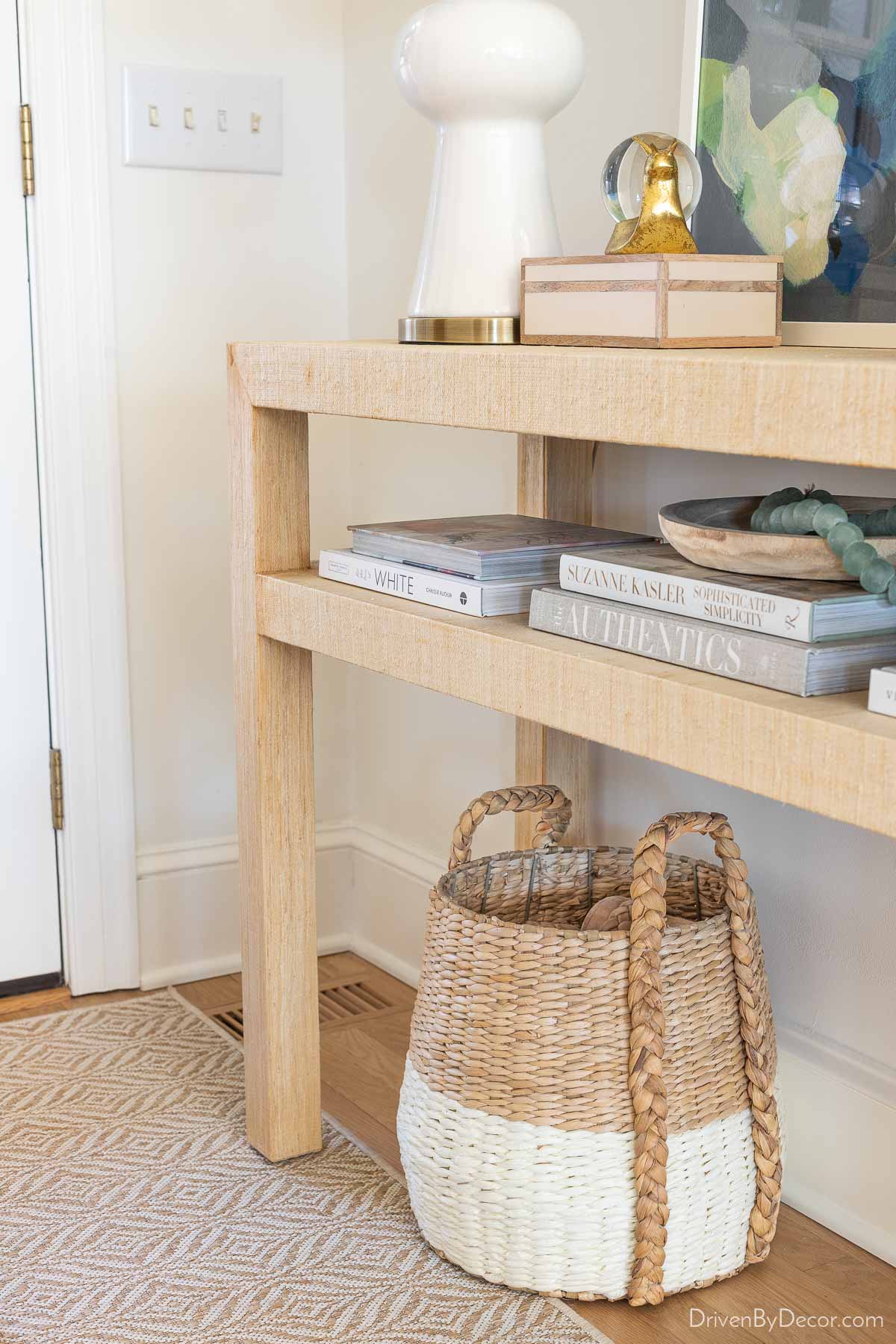 Braided handle basket under entryway console for shoe storage