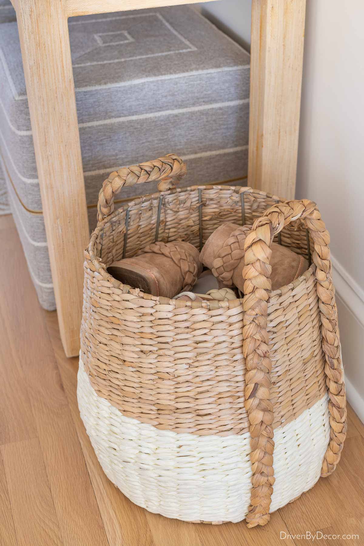 Gorgeous white & natural woven basket filled with shoes for entryways shoe storage