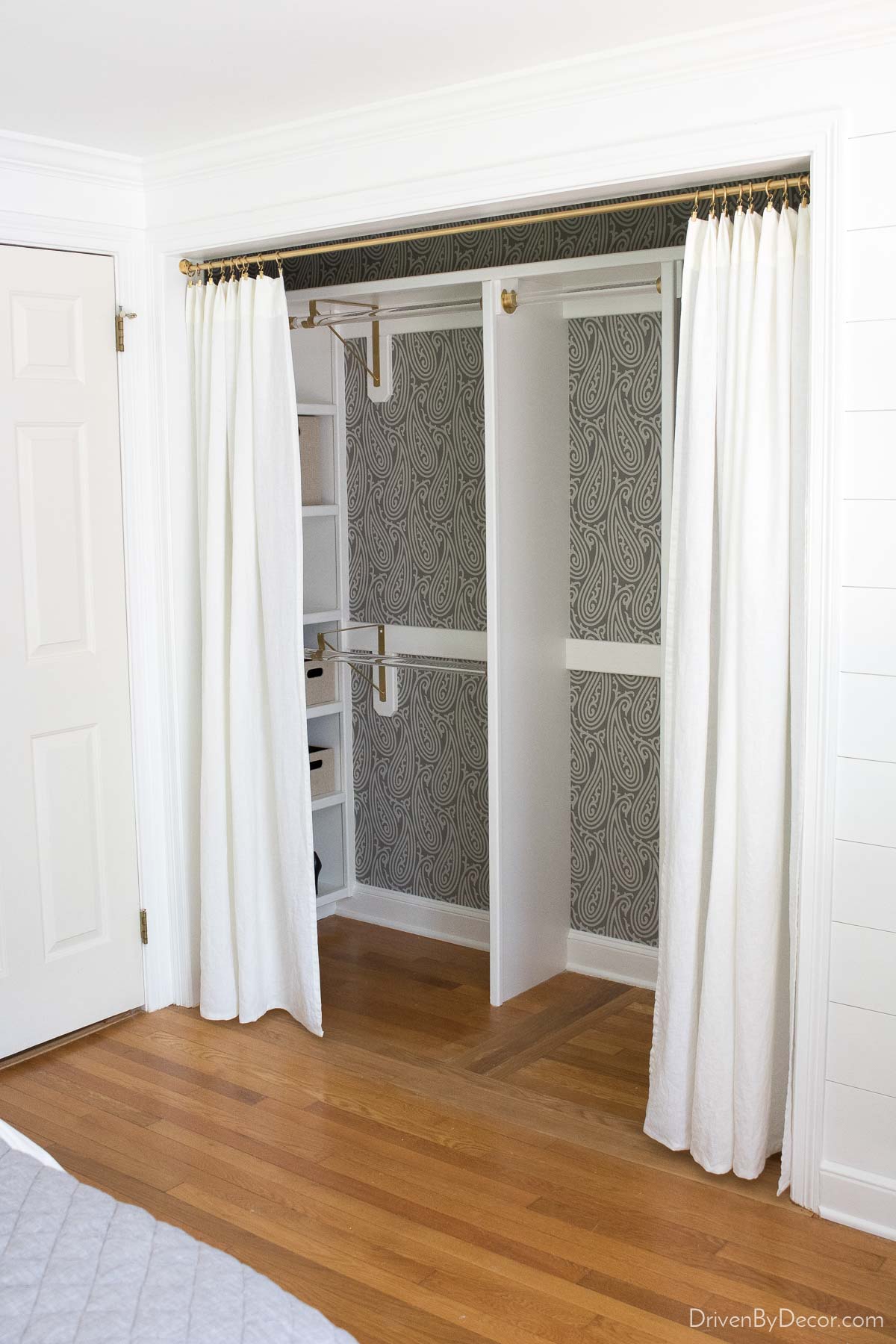 IKEA white curtains hung across closet in place of doors