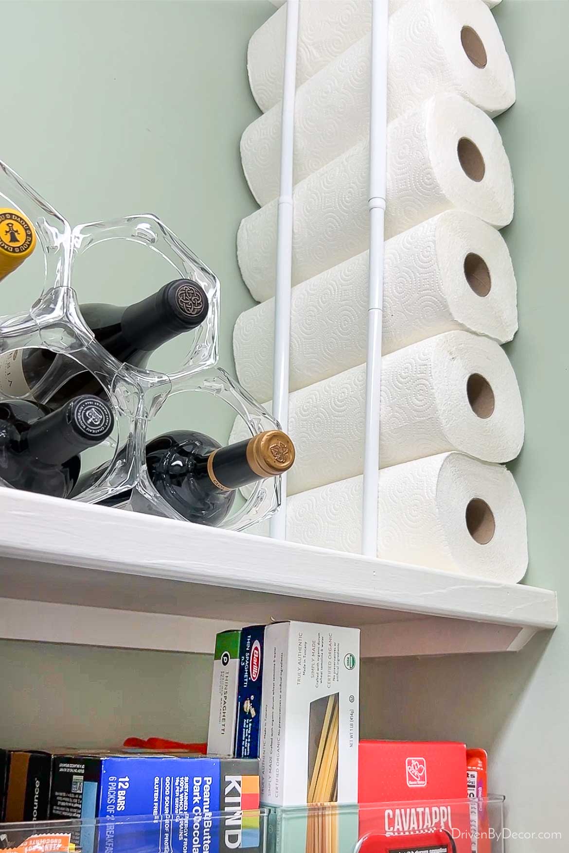 Paper towels stored vertically with use of tension rods