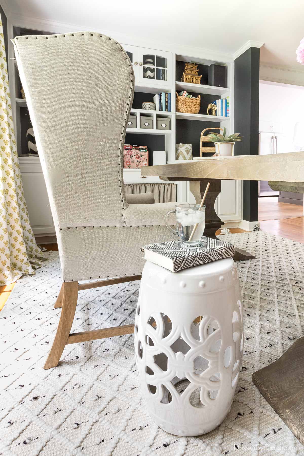 White garden stool next to desk chair in office