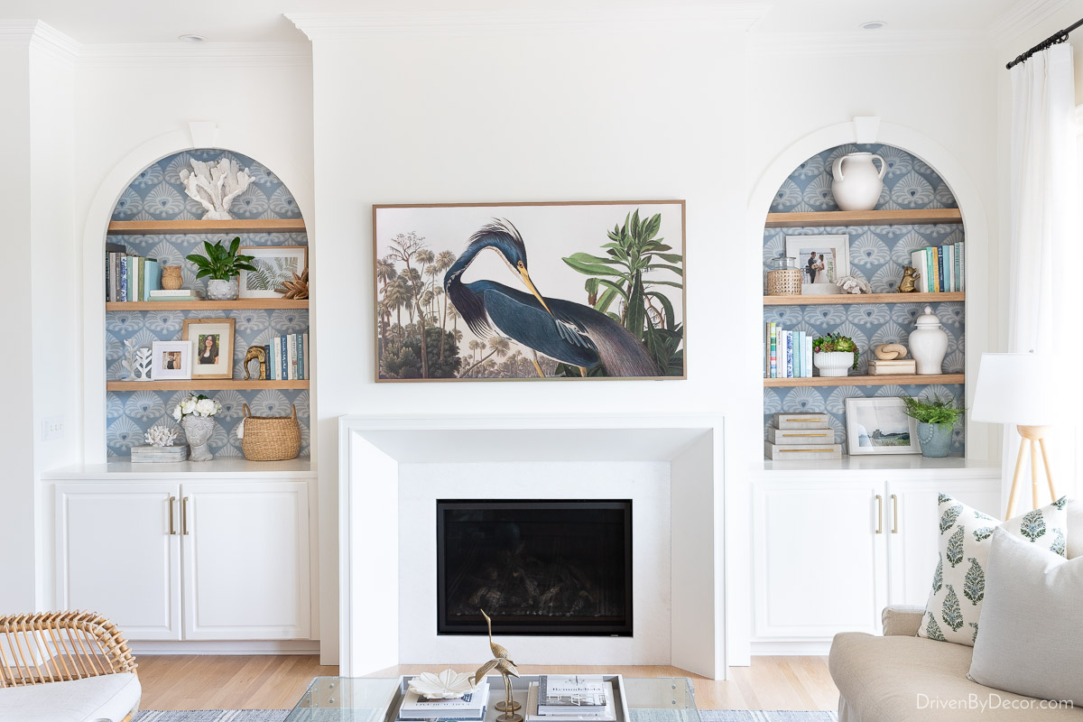 Decorated bookshelves with fireplace in middle