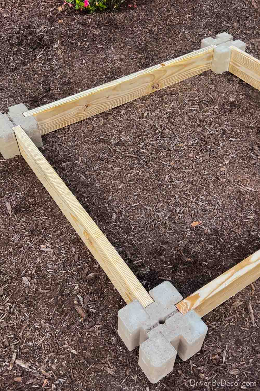 Four corner blocks and lumbar boards for base of raised garden bed