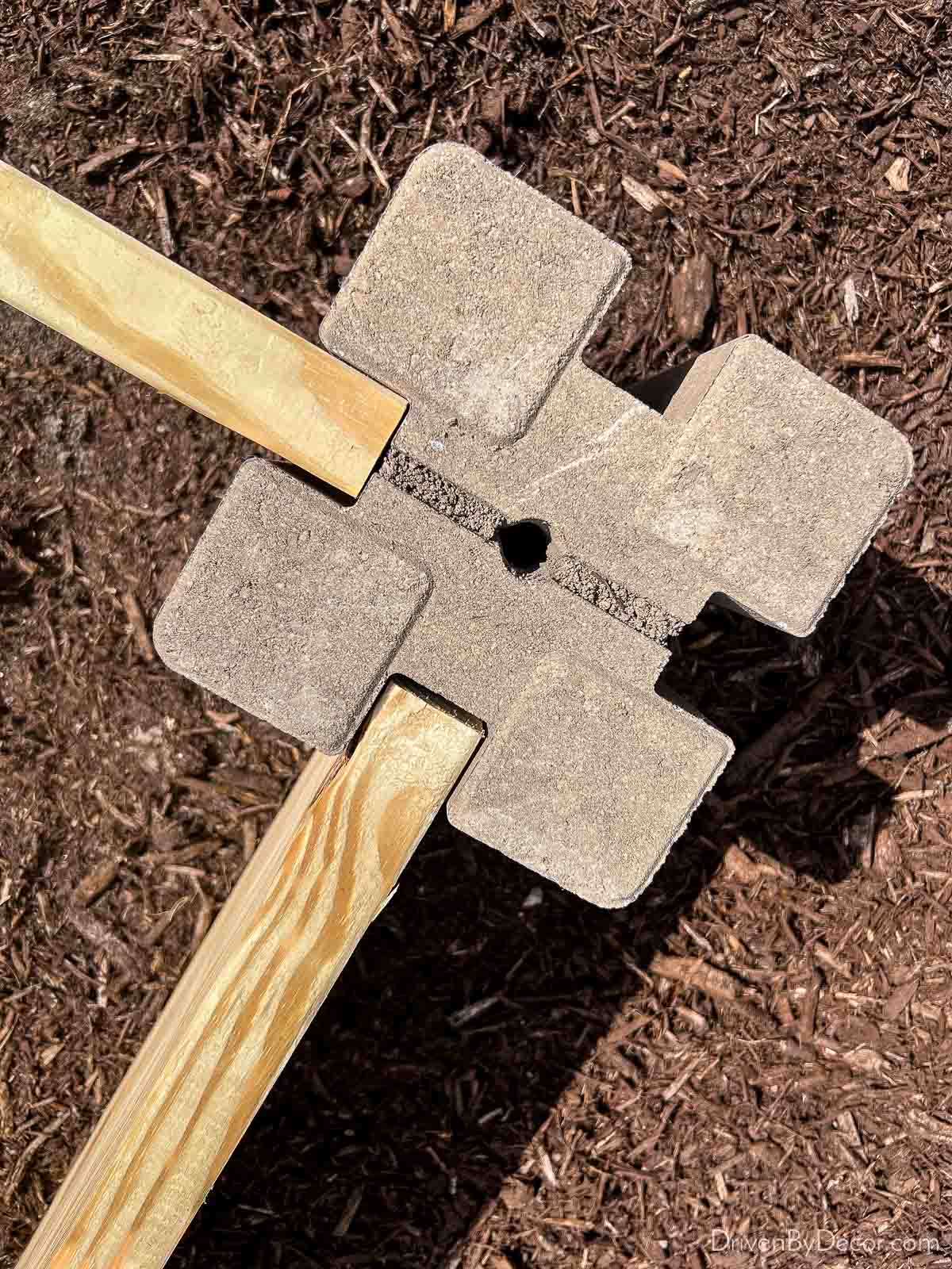 The corner blocks and lumber used to make an inexpensive raised garden bed