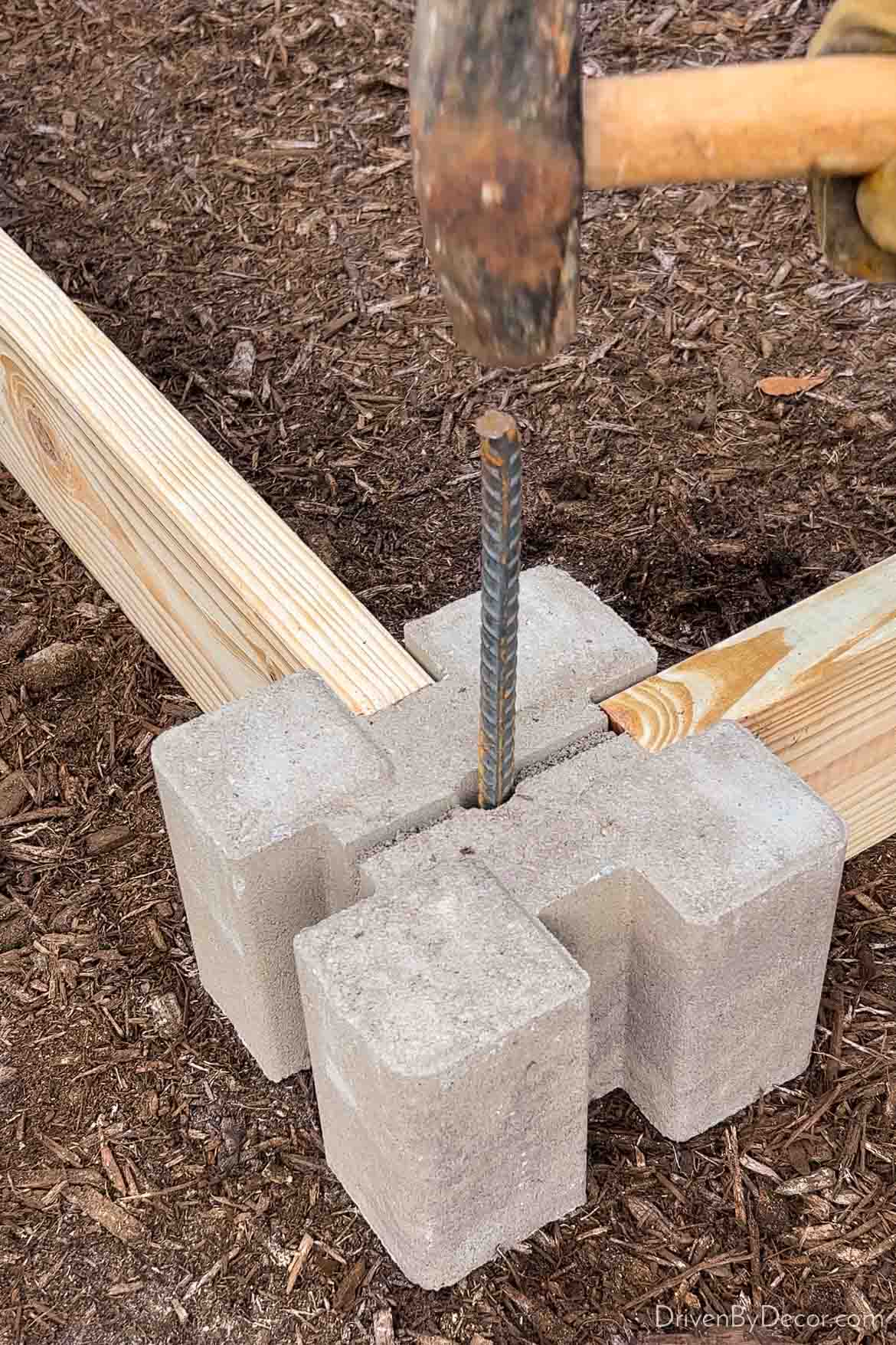 Securing corner of raised garden bed with rebar through the middle of the corner block