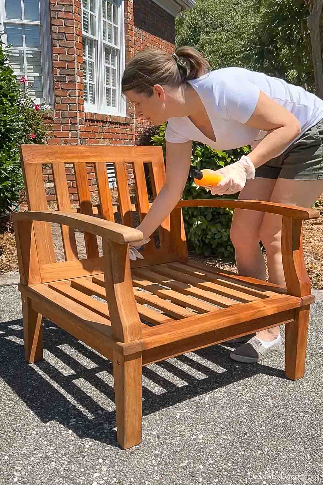 Applying teak conditioner to outdoor teak chair