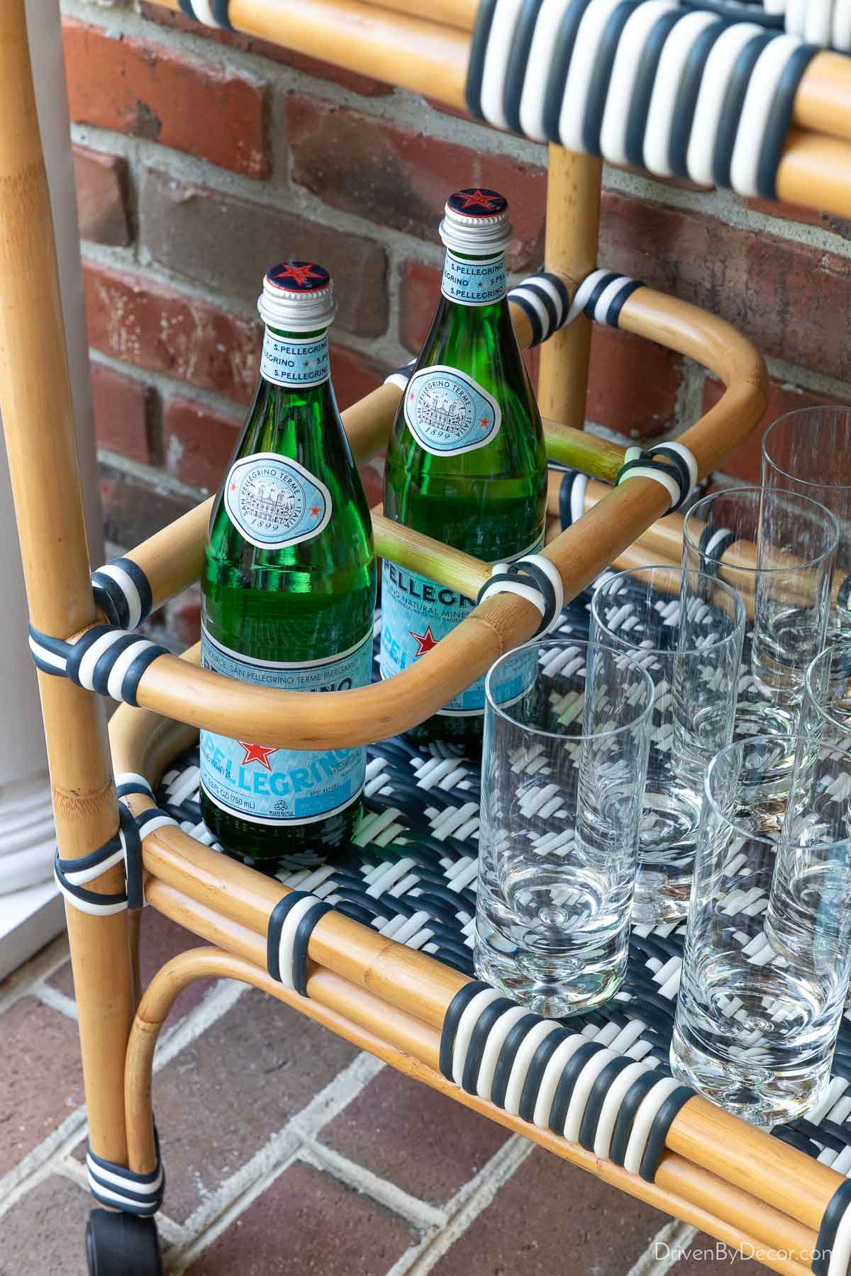 Bottom shelf of bar cart with compartments for holding bottles