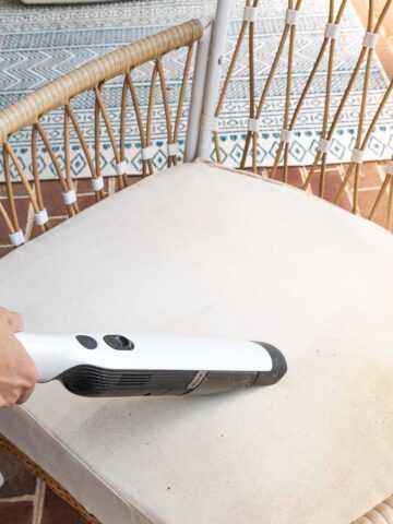 Vacuuming pollen off of outdoor furniture cushions