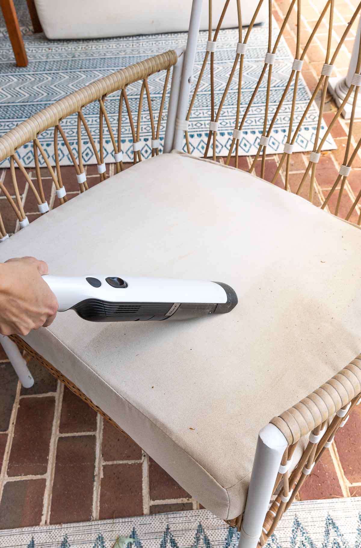 Vacuuming as first step in cleaning outdoor cushions