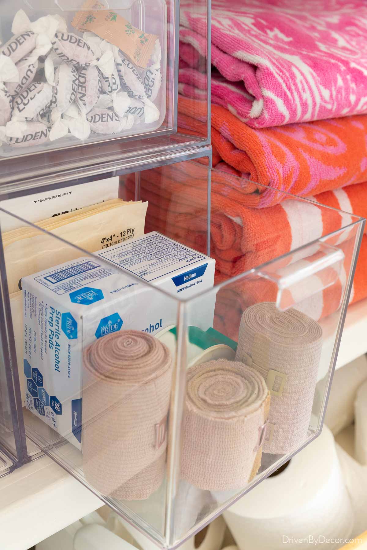 Acrylic drawers in linen closet holding first aid supplies