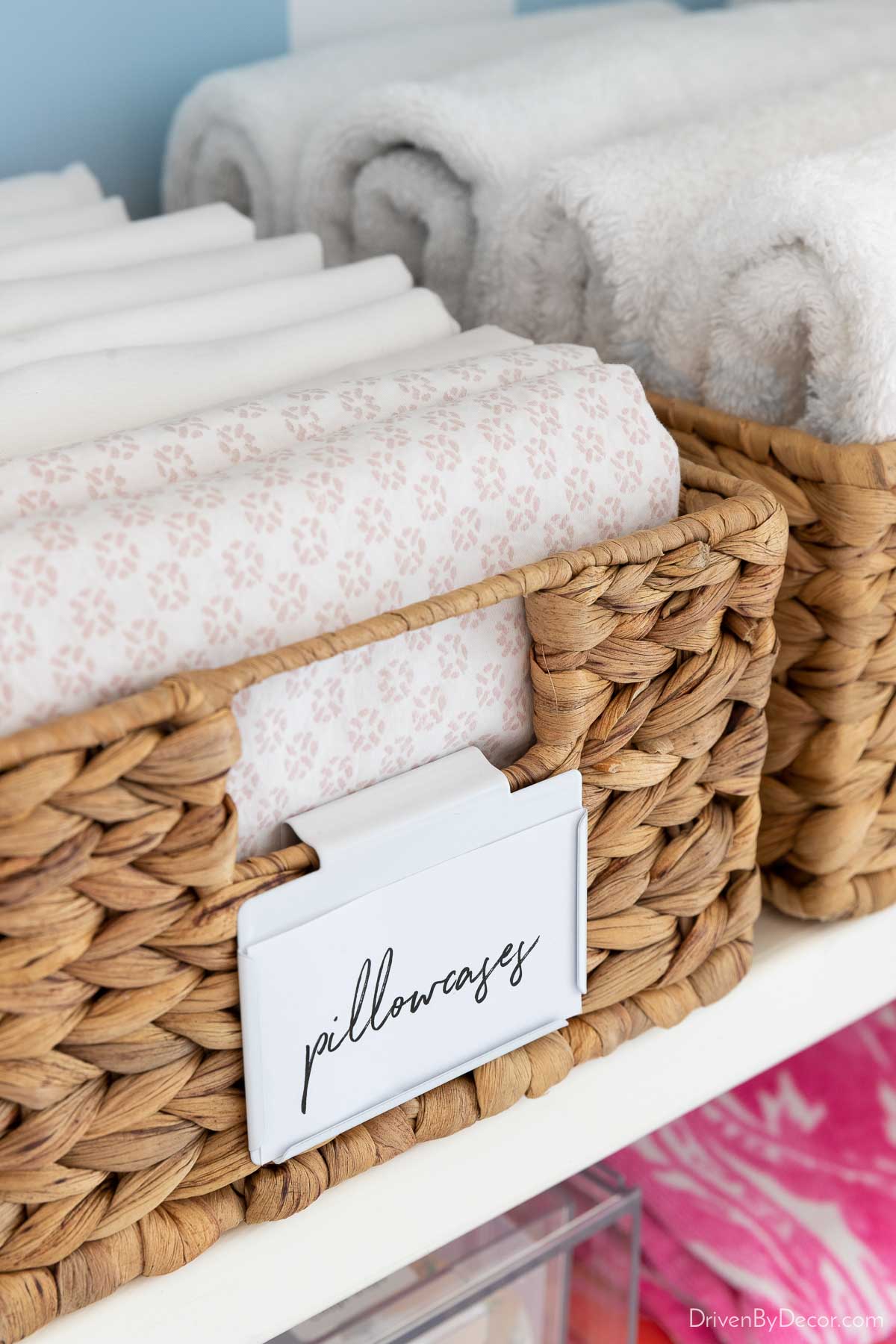 Folded pillowcases in basket in linen closet