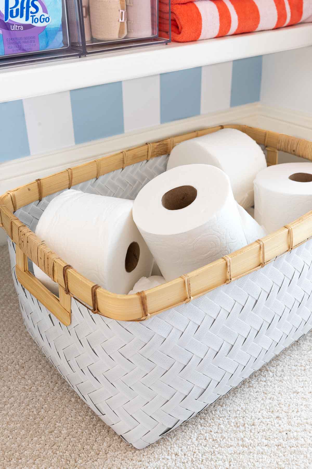 Toilet paper in basket in linen closet