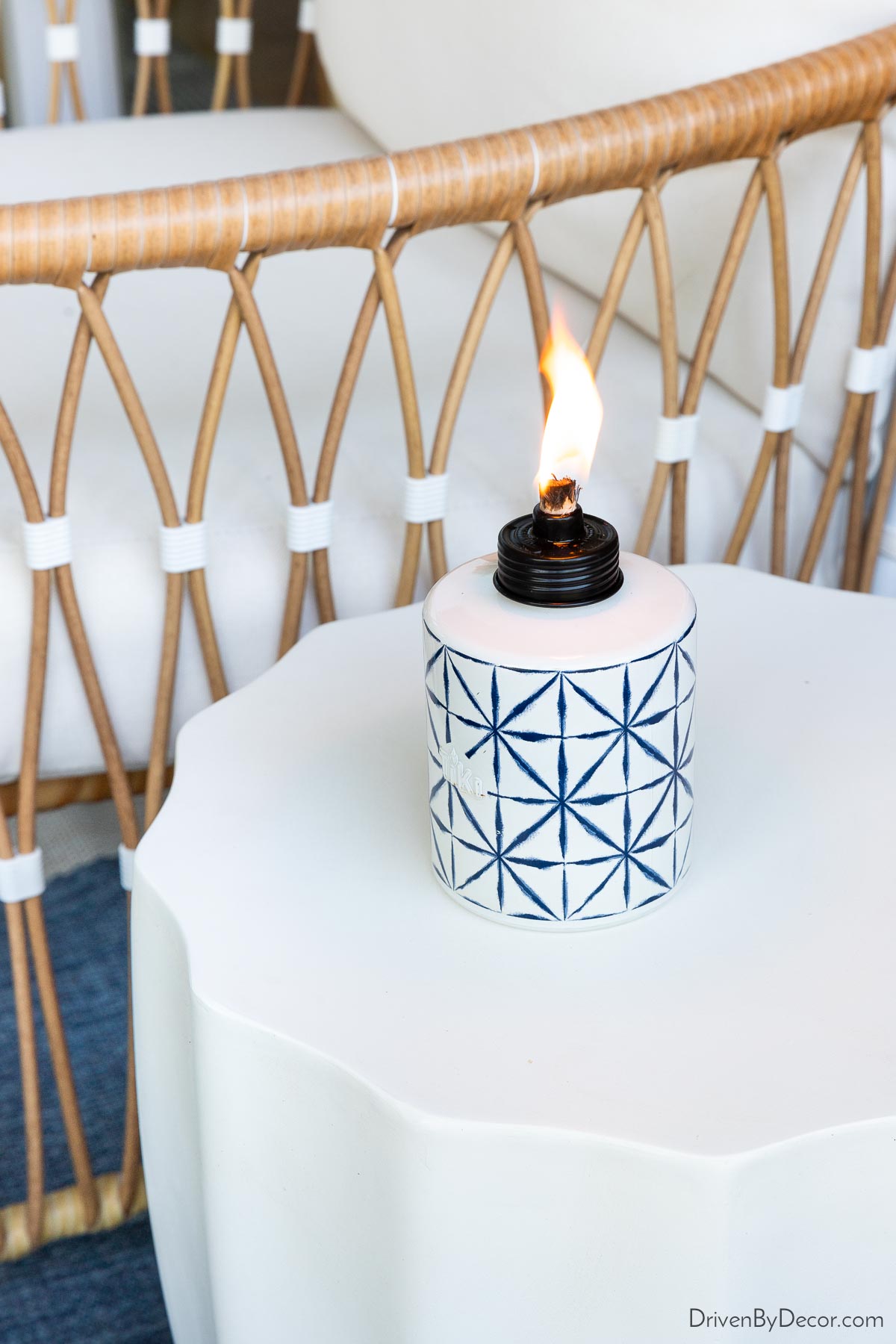 Tabletop tiki torch on outdoor side table for keeping bugs away