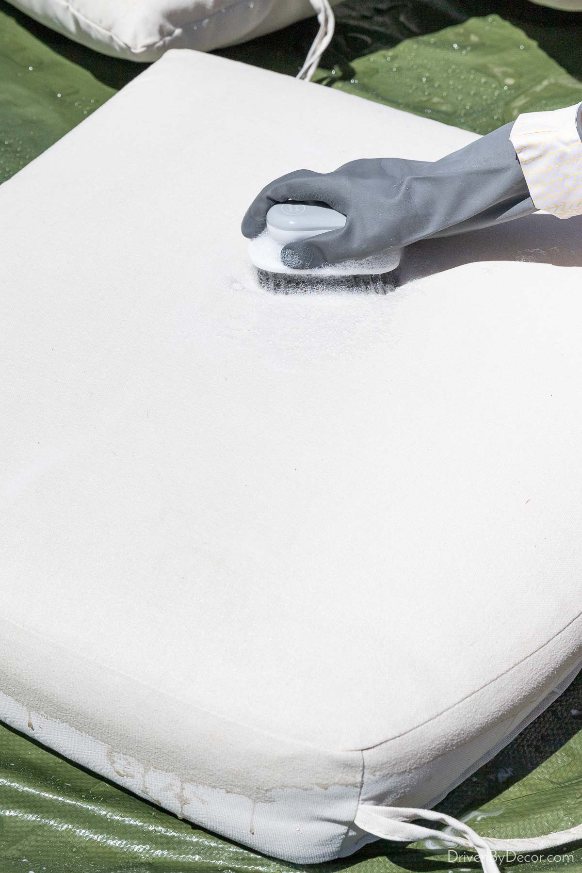 Cleaning outdoor cushion with a scrub brush