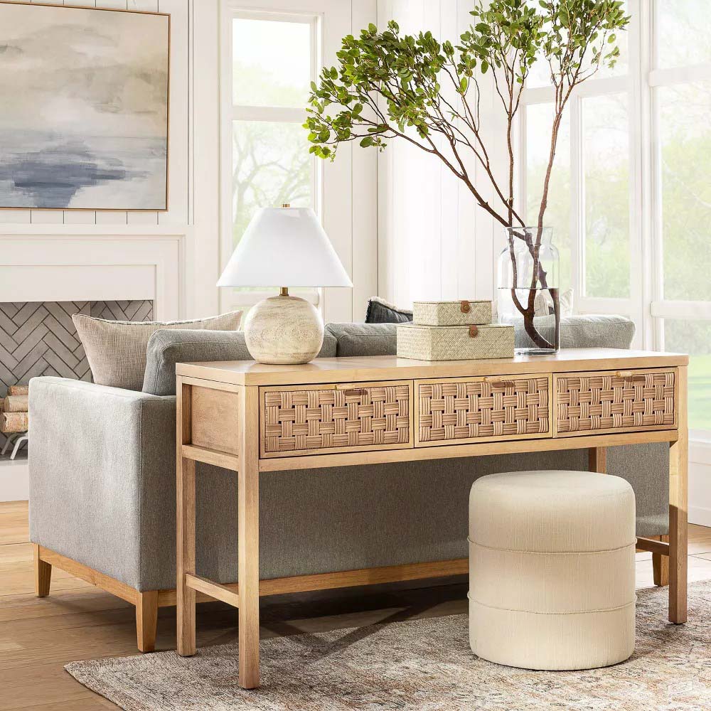 Natural console with woven drawers behind couch