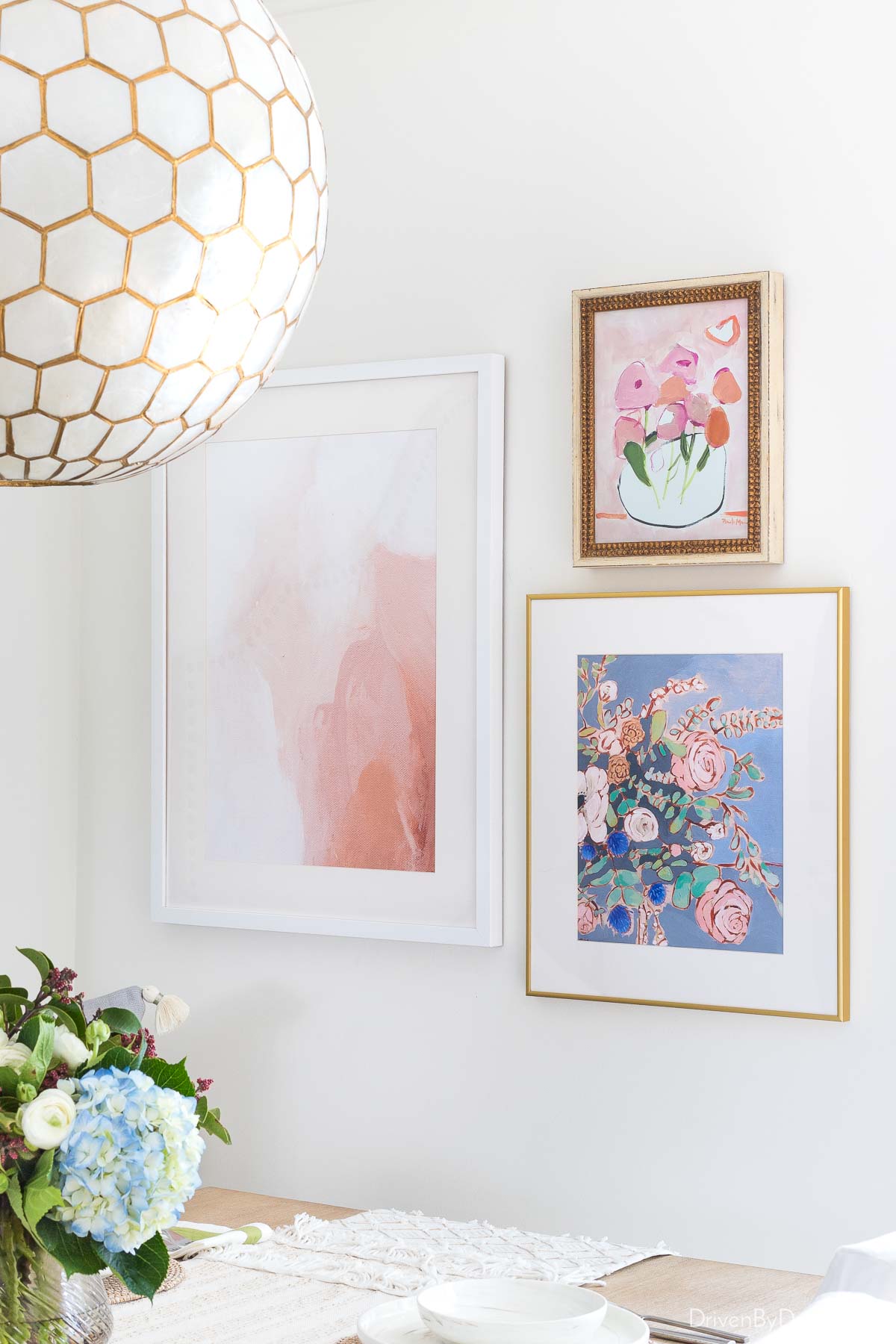 A trio of art pieces hung asymmetrically as a gallery wall