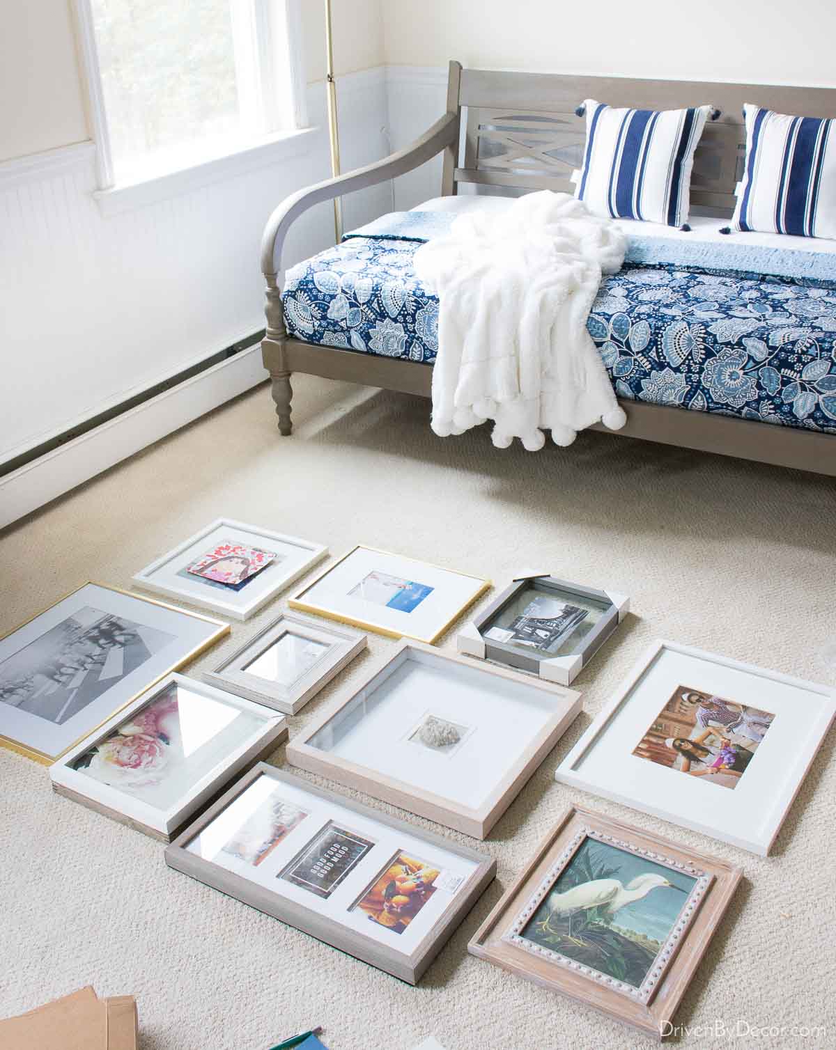 Laying out frames on floor to plan a gallery wall