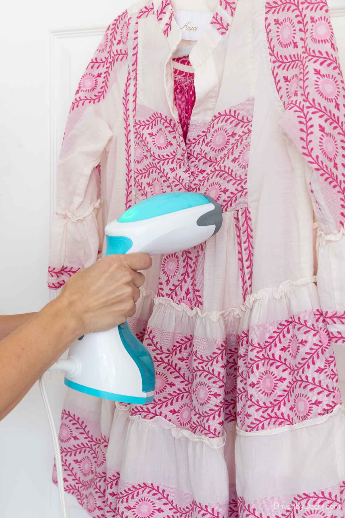 Handheld steamer steaming dress