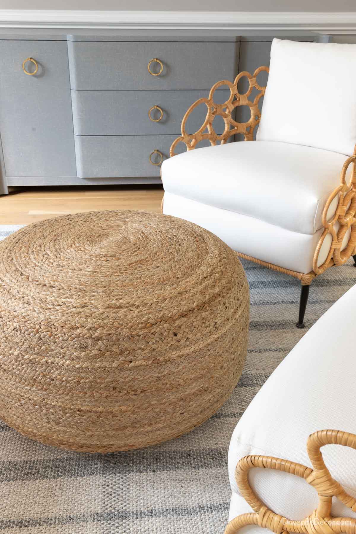 A jute pouf used as a shared ottoman between two chairs