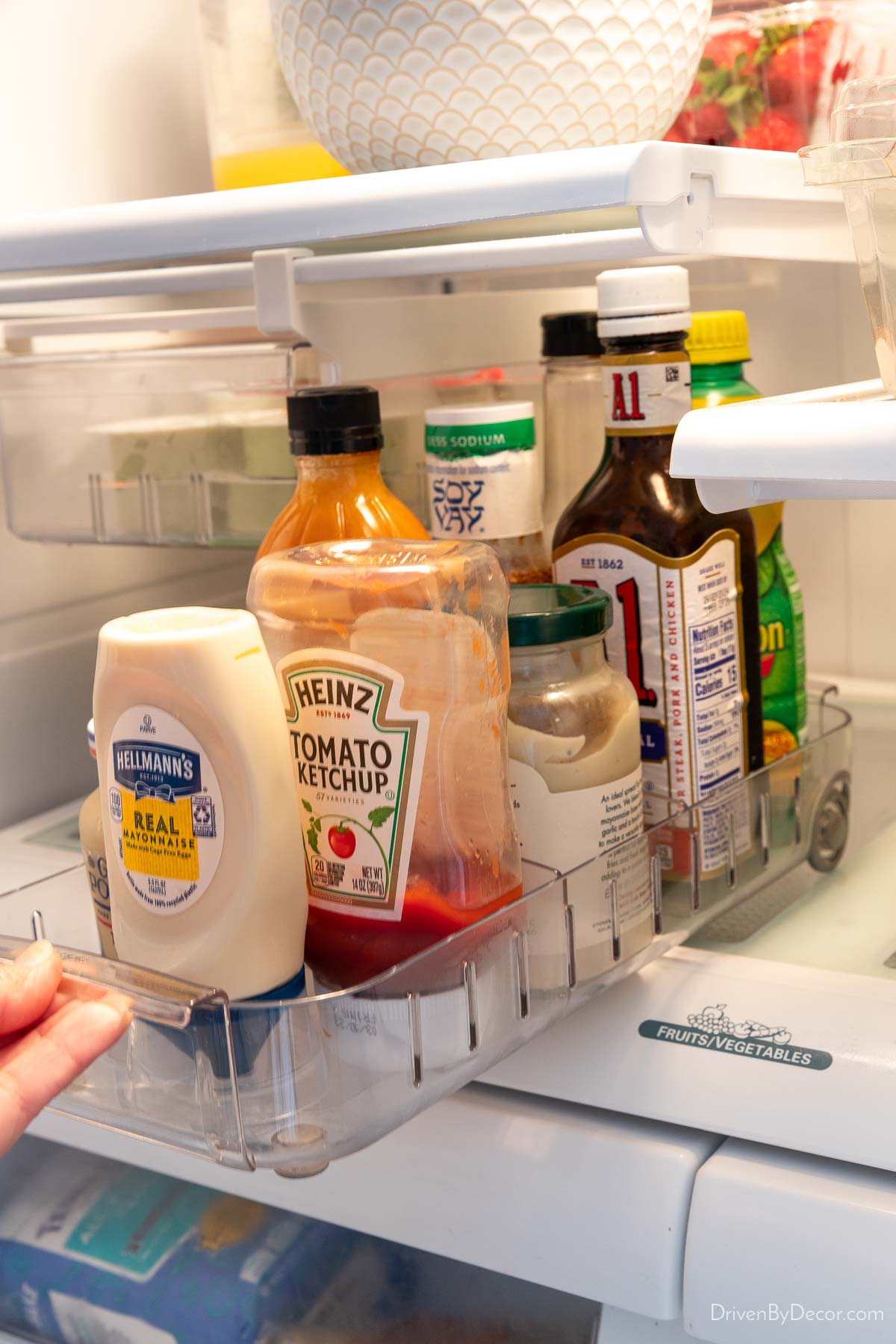 Roll out fridge caddy filled with condiments