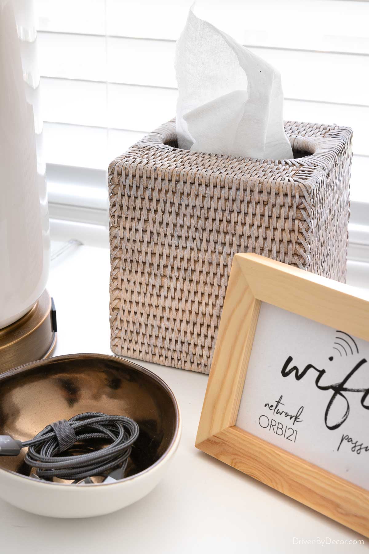 Woven tissue box cover on nightstand