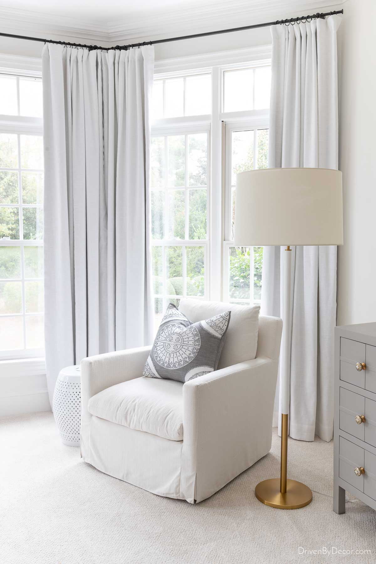 Curtain rod height in a bedroom with chair and lamp