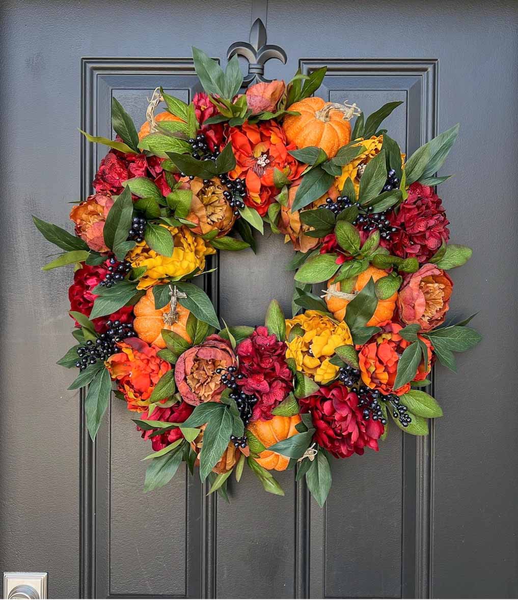 Stunning fall wreath with peonies, pumpkins, and berries