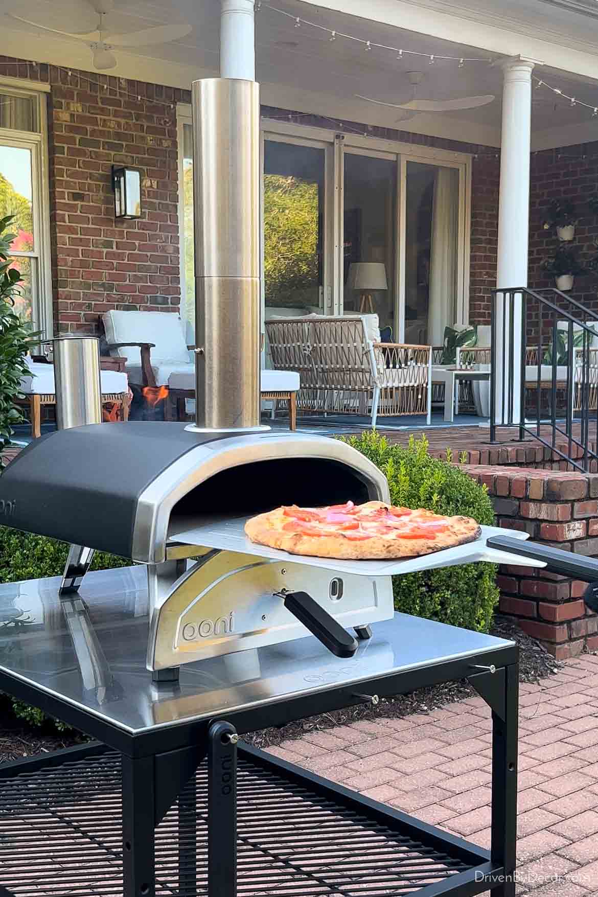 Pizza coming out of Ooni pizza oven