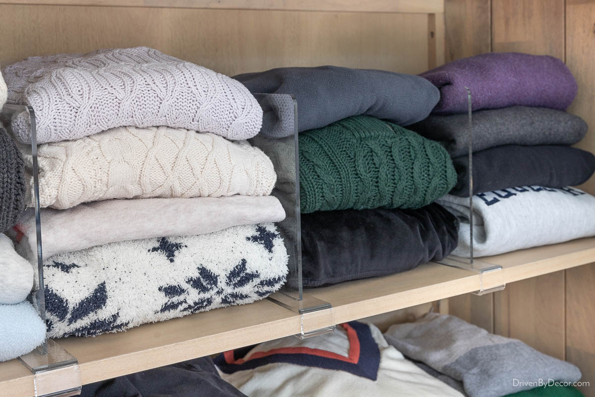 Acrylic shelf dividers keeping sweaters neatly stacked