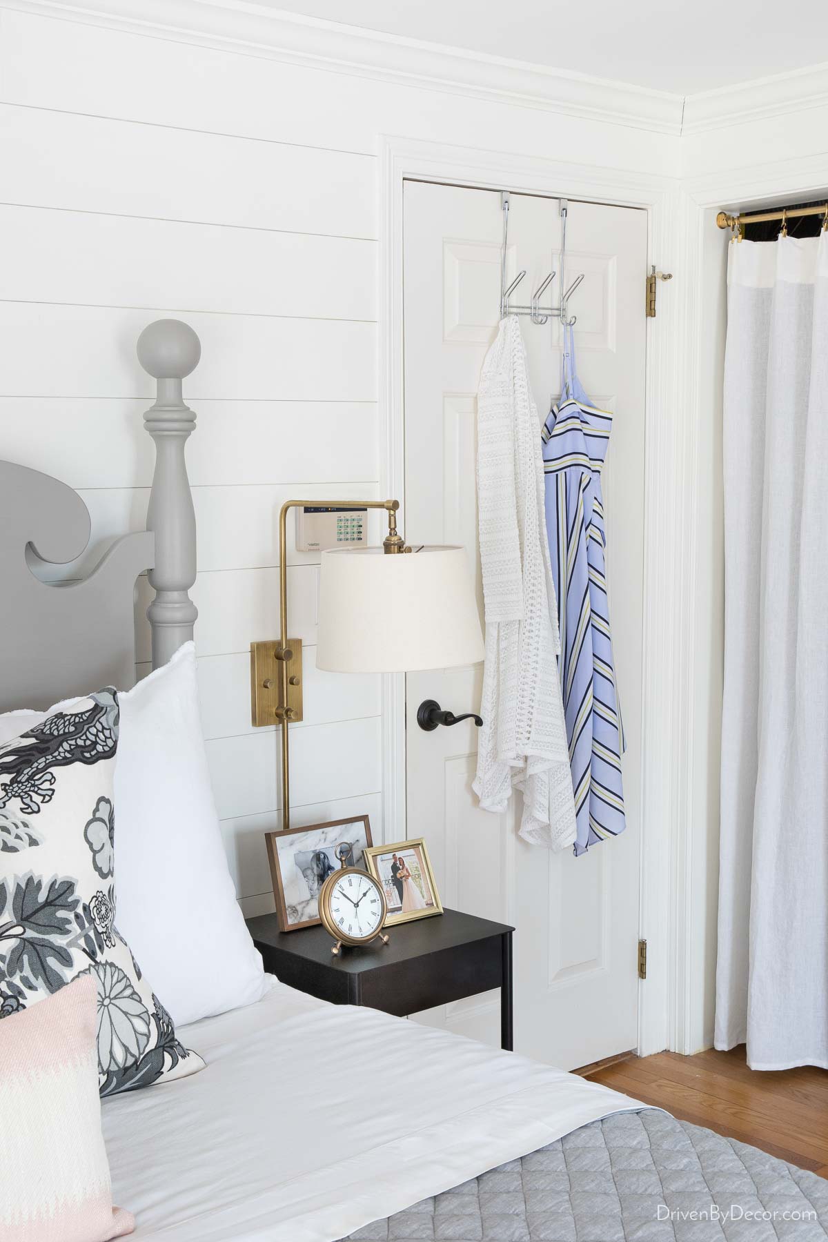 Over the door hanger with three hooks and clothes hanging from it for bedroom organization