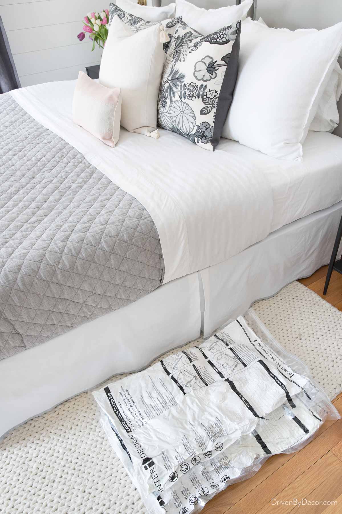 Vacuum storage bags going under a bed as a bedroom organization idea
