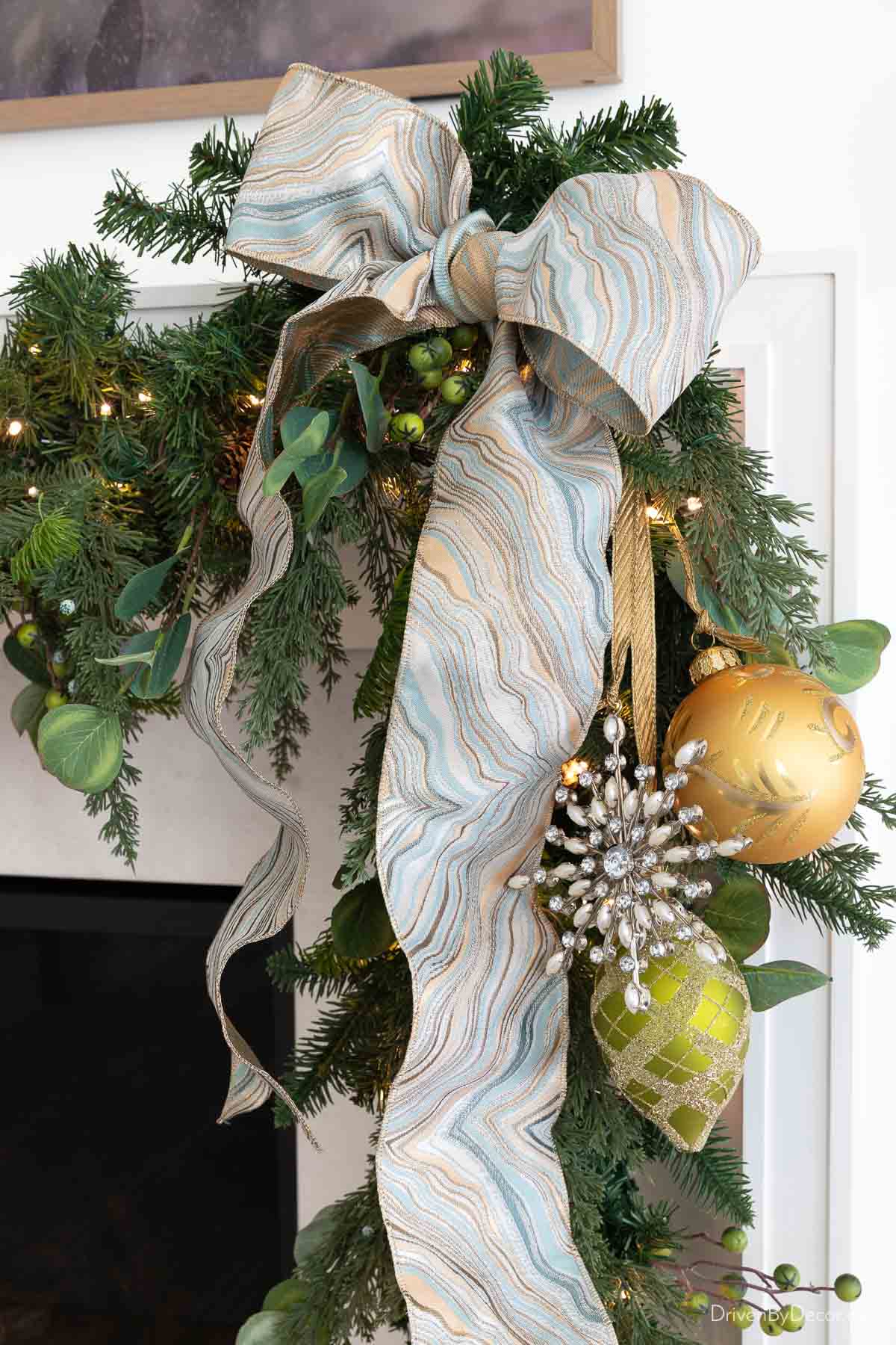 Large bow on end of fireplace mantel garland