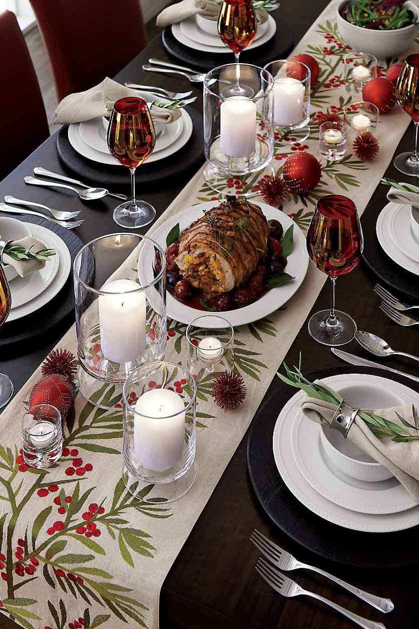 Christmas table with pillar candles and votives interspersed down the length of the table