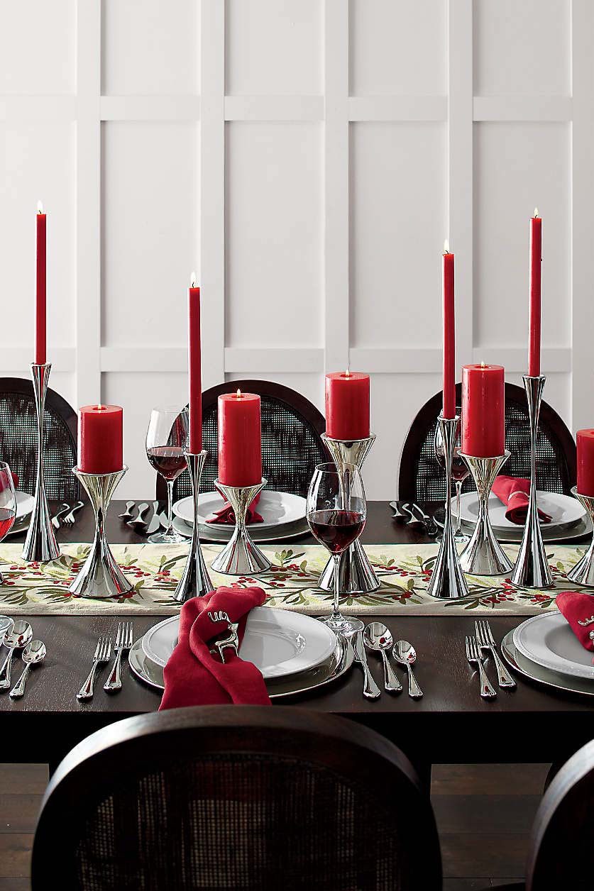 Candlesticks of varying heights along center of Christmas table