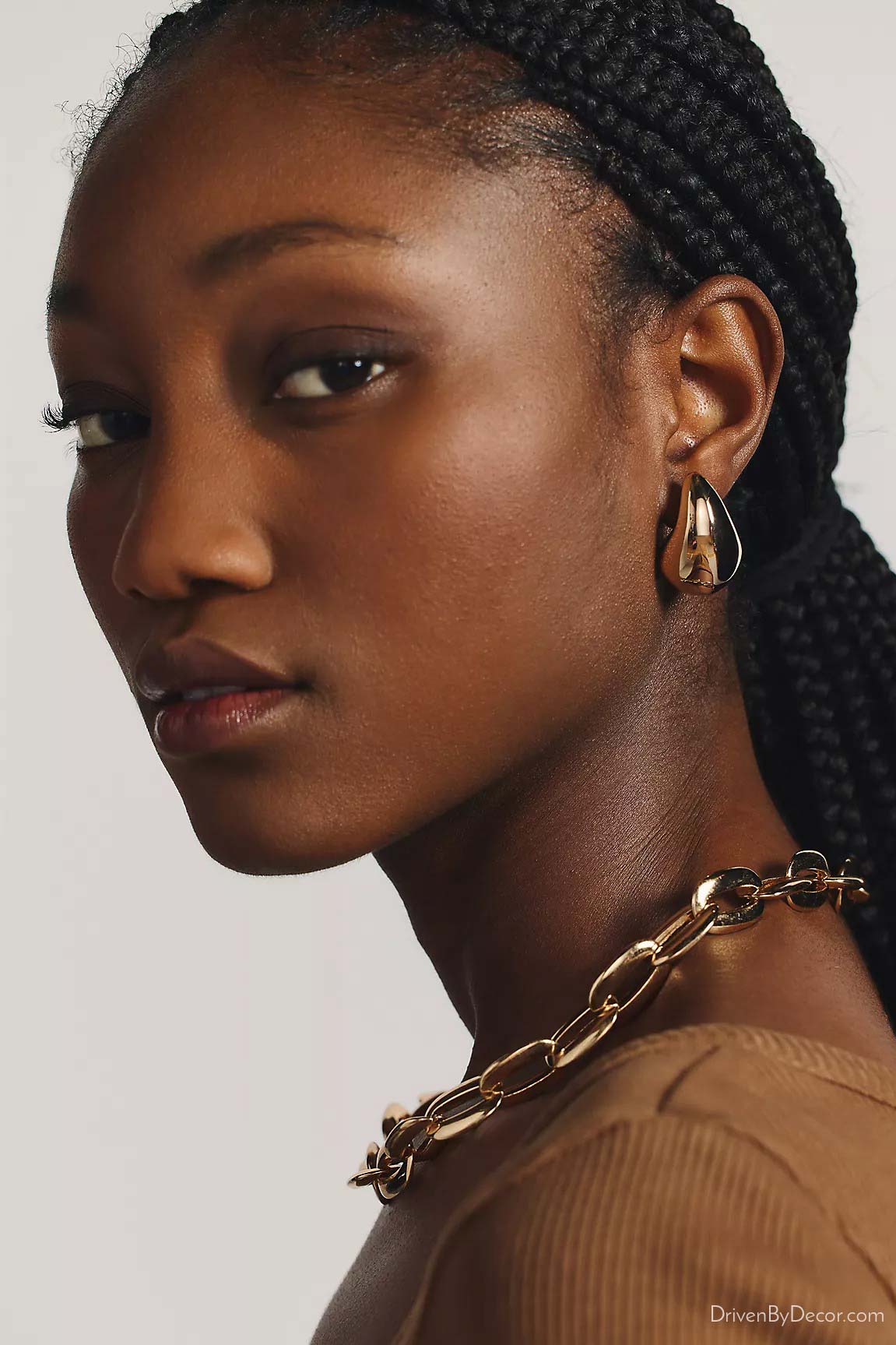 Gold drop earrings on young woman