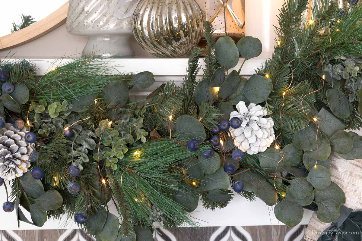 Garland with a mix of greenery on a fireplace mantel
