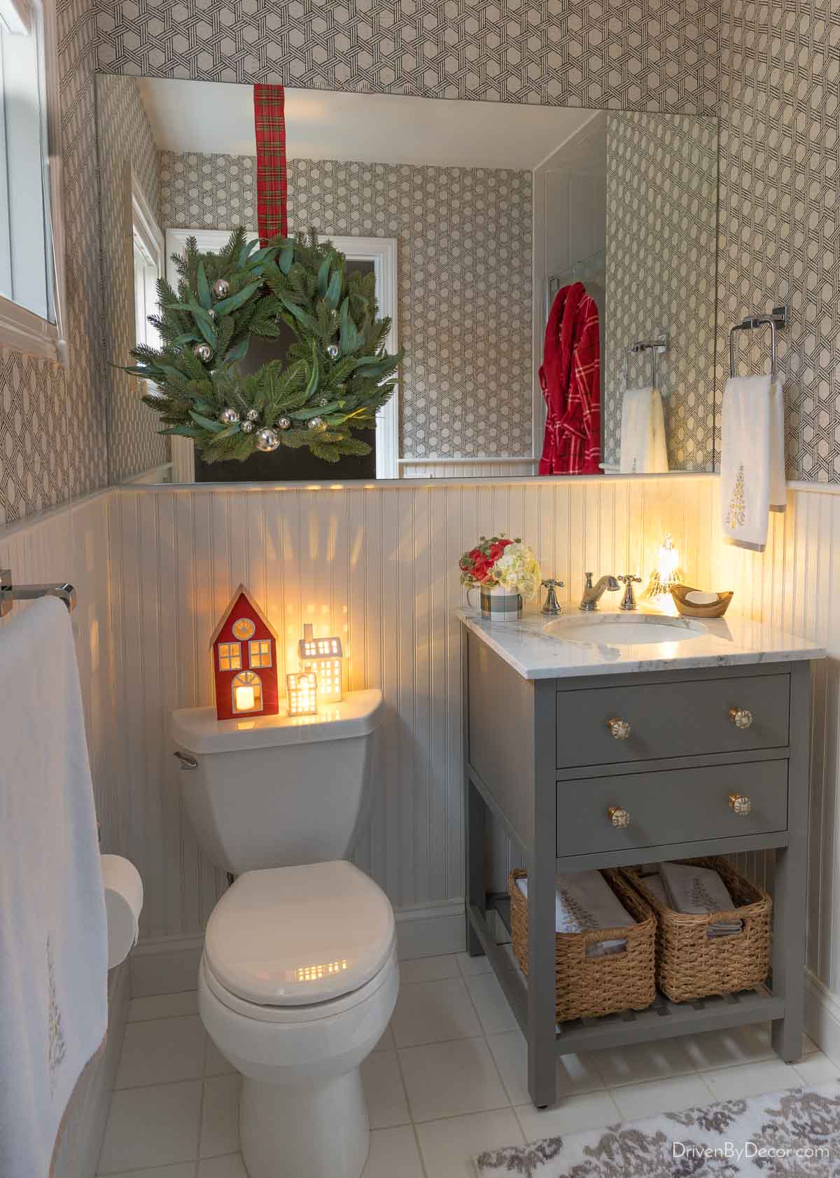 Christmas decor in a bathroom including decorating the top of the toilet tank